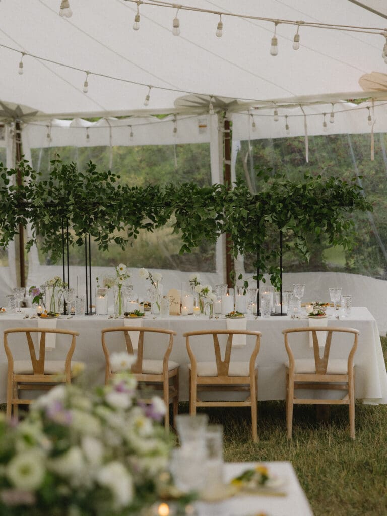 Sailcloth tent reception with greenery and candlelit tables at a Greystone Castle wedding in Boulder, Colorado