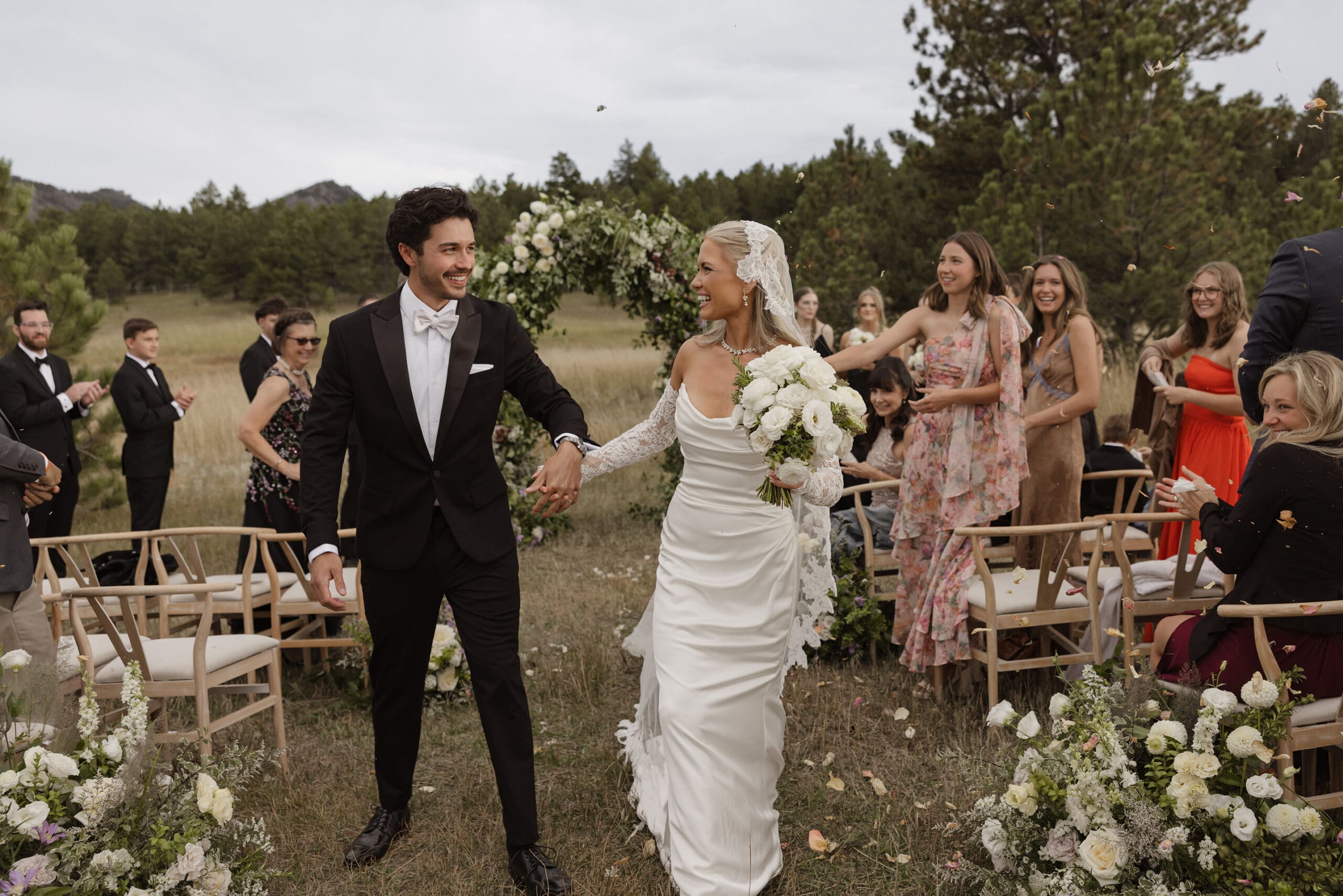 Bride and groom celebrating after their Greystone Castle wedding ceremony in Boulder Colorado